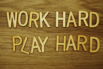 Work Hard Play Hard alphabet letters on wooden background business concept