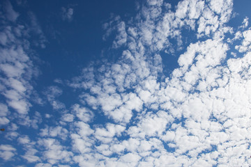 blue sky background with tiny clouds
