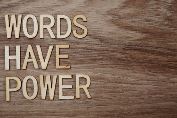 Fototapeta premium Words Have Power alphabet letters on wooden background business concept