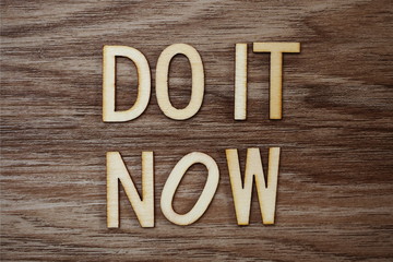 Do It Now on wooden background business concept