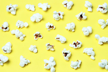 pattern of popcorn on a yellow background close-up, top view, texture