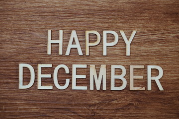 Happy December text message on wooden background