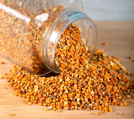 Pollen in a glass jar on wooden background