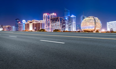 Obraz premium Road Pavement and Night View of Hangzhou Urban Architecture..