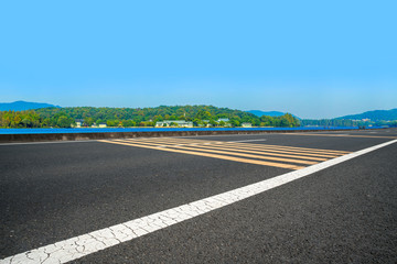 Empty asphalt road and natural landscape under the blue sky