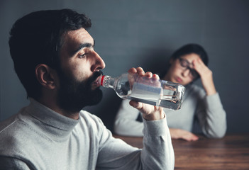 woman with alcohol bottle man