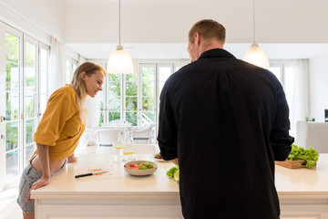 Couple cooking on a white kitchen at home