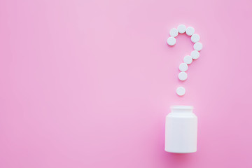 Close up of pills. Dietary supplements. Variety pills. Vitamin capsules on pink background