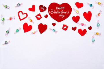 Valentine Day concept, white background with red hearts and sweet candy