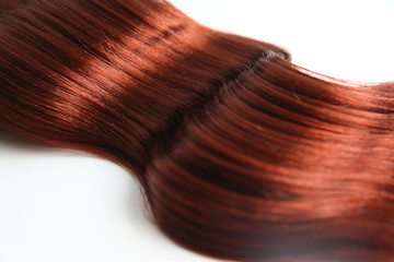 Red wavy hair extension isolated