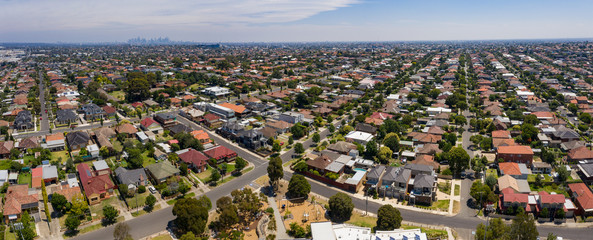 Panoramic aerial view of the suburb of Preston in Melbourne, with the city high rise buildings in the background. - obrazy, fototapety, plakaty