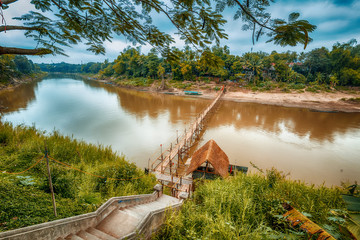 Travel to Laos, Southeast Asia, view of the famous Asian Mekong River and bamboo bridge. Beautiful landscape and popular travel destination. Luang Prabang