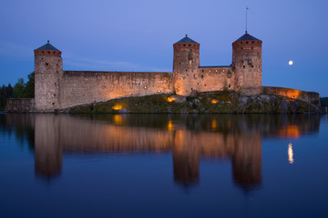 Old fortress Olavinlinna close-up on a July night. Savonlina, Finland
