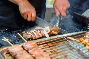 Hand cook using knife cutting squid slices