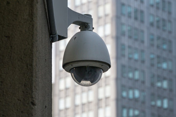 Surveillance Security Camera in the Big City with buildings and windows in the background