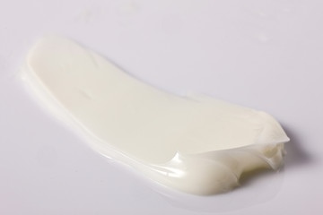 cream texture with white background. lotion texture.