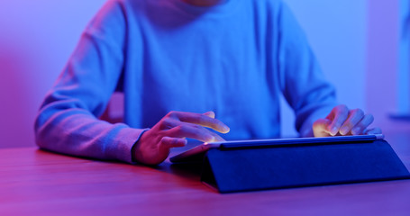 Work on tablet computer with purple light