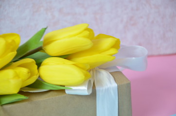 Fresh beautiful yellow tulips gift box on colorful background. Spring concept. top view with copy space. Happy mother day, hello spring, 8 march women day