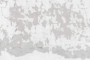 Concrete wall texture background with grey grungy stucco, white peeled paint, cracks and stains