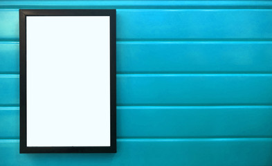 beautiful notification borad hanging on the colorful metal wall, black frame placing on bright blue wall, square black pan on colorful blue background