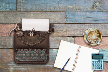 Vintage typewriter on the old wooden desk 