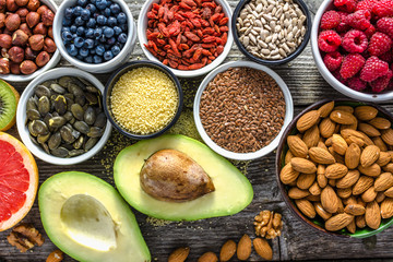 Selection of vegetarian food. Healthy superfoods, bio products for vegan diet with avocado, fruit and organic berries. Fresh nourishment on table. Breakfast in a bowls with different ingredients.