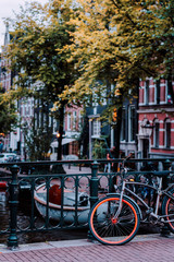 Bike parked on a bridge in Amsterdam, Netherlands. Typical cityscape