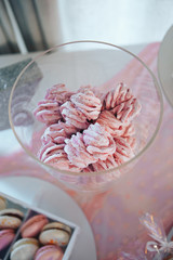 Pink meringues in glass jar. Gentle dessert