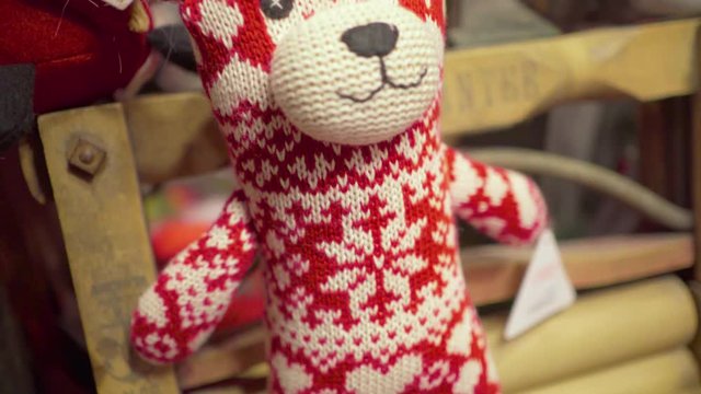 Santa Claus Christmas house in charming Scandinavian village - toys overview - red and white teddy bear Mr. bean style - close up macro shot with blurred background
