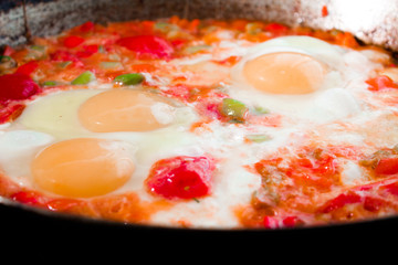 morning omelet on big cast iron pan on black background