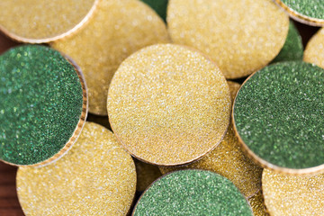 fortune, luck and money - close up of golden and green coins