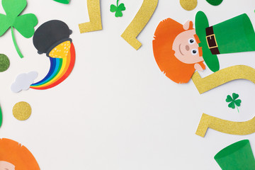 holidays and celebration concept - st patricks day decorations or party props made of paper on white background