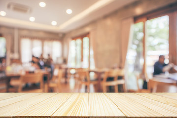 Restaurant interior with customer and wood table blur abstract background with bokeh light