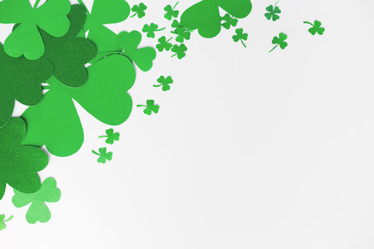 fortune, luck and st patricks day concept - green paper shamrocks on white background