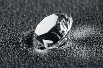 close up of pure diamond on grey textured background