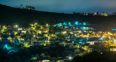 Night scene in the valley with bright houses with colorful lights makes the night scene in the countryside more vibrant in the Da Lat plateau, Vietnam