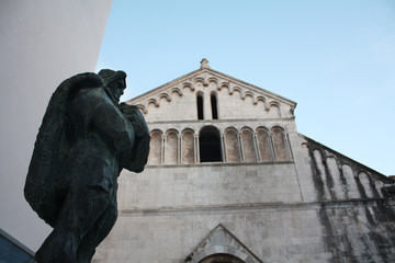 The Church of St. Chrysogonus with not finished Bell Tower and Statue in front of the Chrysogonus. Zadar. Croatia.