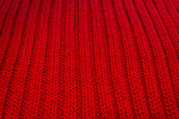 Texture of red knitted scarf close-up, red knitted wool 