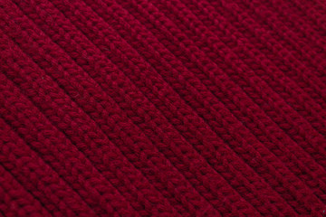 Texture of red knitted scarf close-up, red knitted wool 