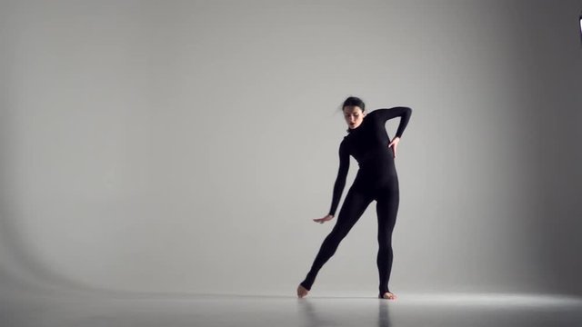 Flexible woman dancing in studio