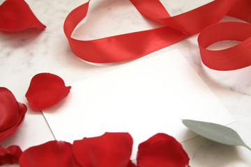 Beautiful bright red rose petals. Valentine's day. red silk ribbon. symbol of love. cards design, macaroons, eucalyptus