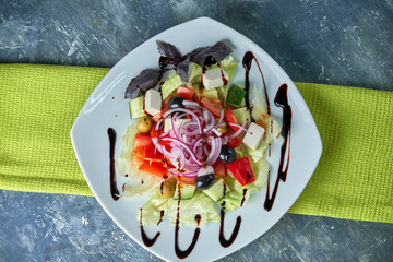 Greek salad with fresh vegetables, feta cheese and black olives