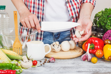 Woman cooks at the kitchen, body part, blurred background