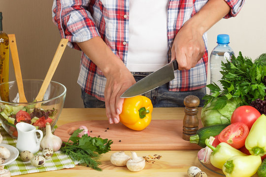 Woman cooks at the kitchen, body part, blurred background