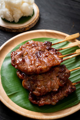 grilled skewered milk pork with white sticky rice