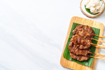 grilled skewered milk pork with white sticky rice