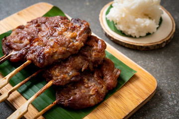 grilled skewered milk pork with white sticky rice