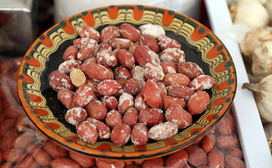 Peanuts. Bowl of aromatic roasted peanuts with salt. Oval seed of a South American plant, roasted, fried and salted and eaten as a snack. 