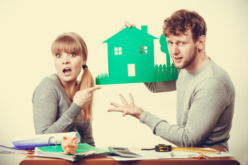 Young couple with ecological green house.