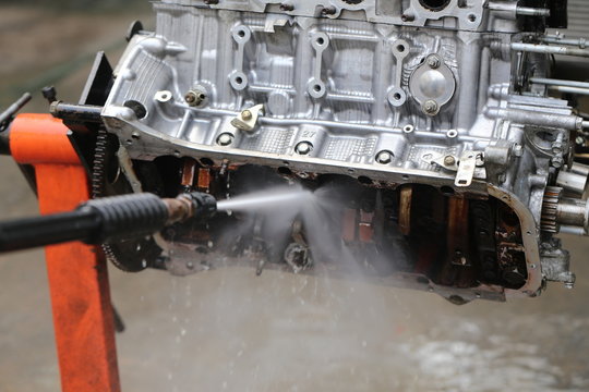Hand cleaning car's engine